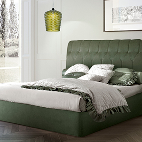 _Mister button-tufted bed 
       upholstered in fabric.