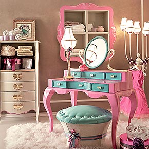 _Toilette Rimmel in legno, struttura in finitura fuxia lucido cat. A, frontali cassetti in finitura turchese lucido cat. A, maniglie di metallo fiocco e bracci specchiera in finitura foglia oro, cat. C</br>
_Pouff contenitore Muffin in legno con basamento in tessuto 1742/30 cat. B e seduta con perle in tessuto Luce/39, cat. B</br>
_Settimino Arabesque in legno con 4 cassetti e 2 vani a giorno, finitura struttura pistacchio, cat. B, maniglia modello fiocco in metallo finitura foglia oro, cat. C