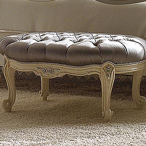 NOUVELLE L.74 H.36 P.55 cm</br>
_Pouff Nouvelle capitonnè in legno, finitura Luise avorio con particolari foglia argento, cat. B, con rivestimento capitonnè in tessuto Caravaggio Platinum, cat. D