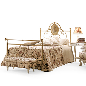 _Carolina hand-forged iron bed 
                 ceramic-coated ivory finish, cat. B.
                <br>
                _Karol wooden night tables 
                 with swing metal handle, 
                 ivory crackle finish, cat. B.
                <br>
                _Rina wooden table lamp
                 antique ivory polychrome finish, cat. D. 
                <br>
                _Barone wooden armchair
                 in worn ivory finish, cat. B.
                <br>
                _Regina Buttoned pouff.